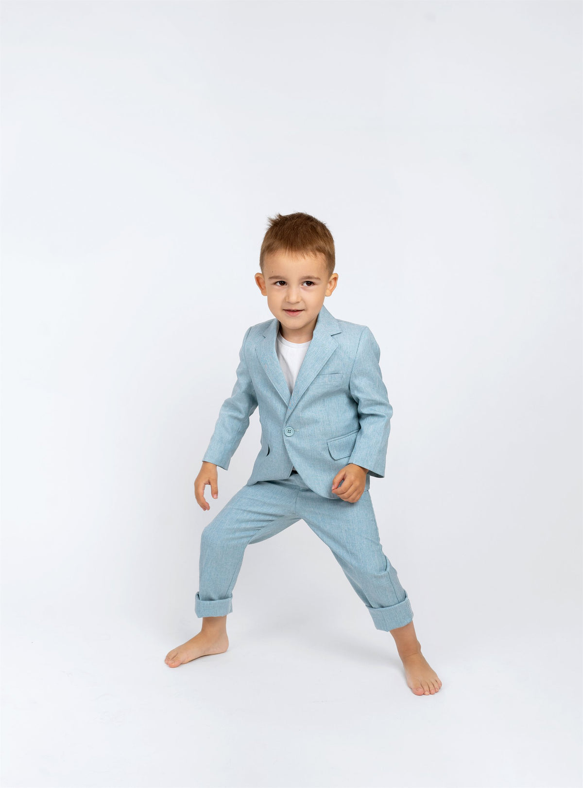Young boy wearing a light blue linen suit