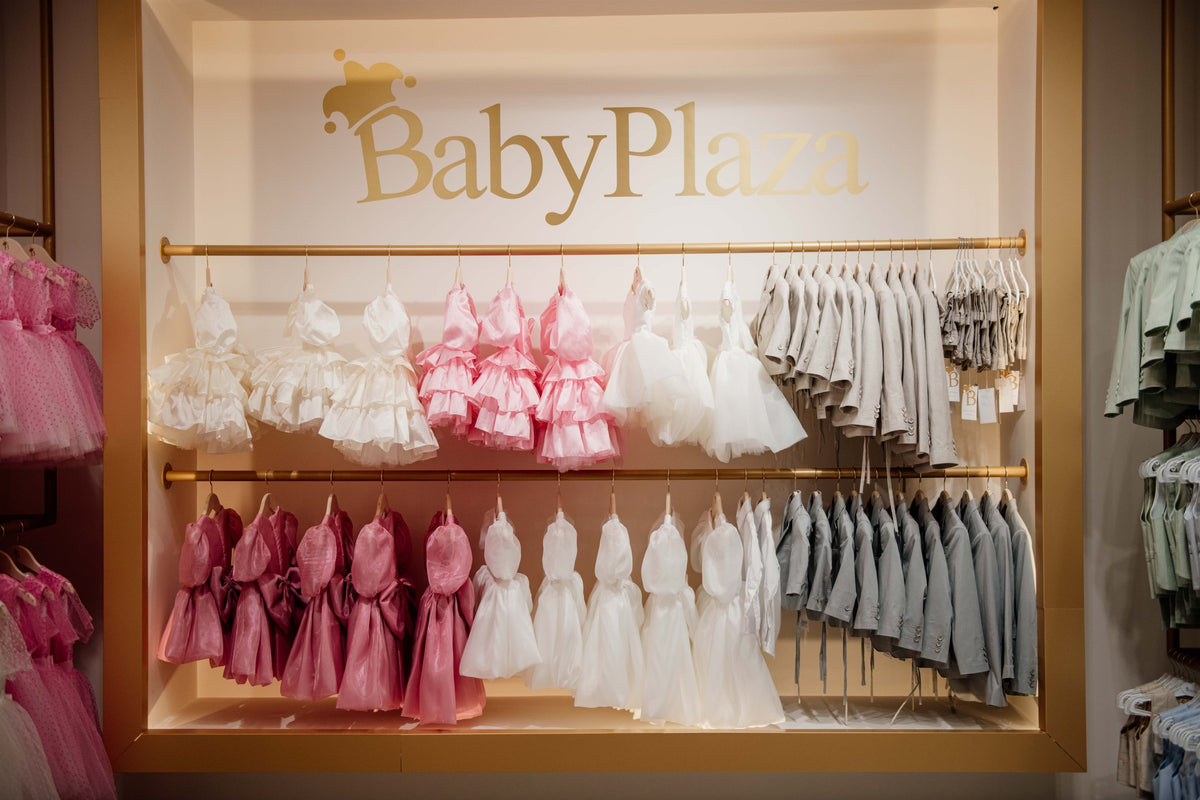 Baby Plaza store display of elegant children's dresses and suits